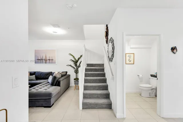 a living room with furniture and a toilet