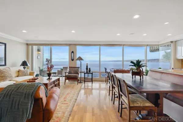 a living room with furniture a wooden floor and chandelier