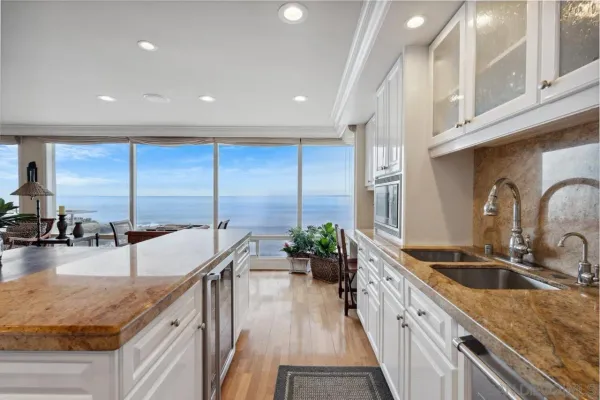 a kitchen with stainless steel appliances granite countertop sink stove and cabinets