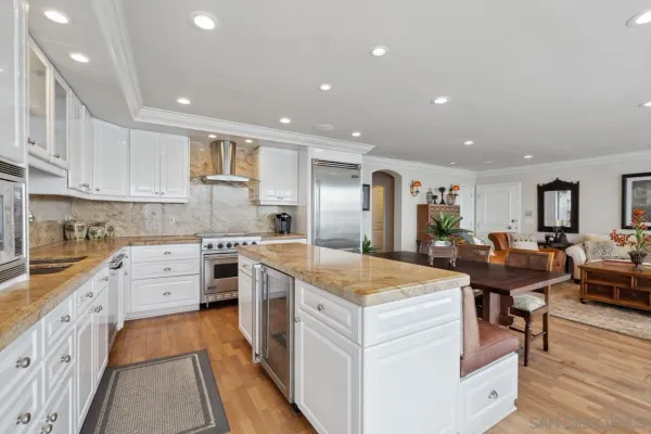 a kitchen with stainless steel appliances granite countertop a refrigerator and a stove top oven