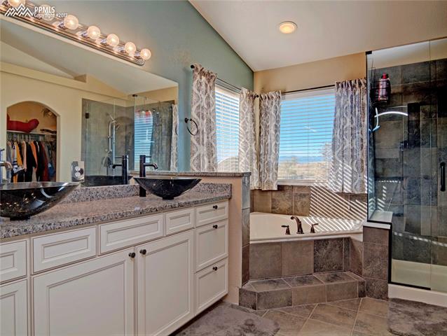 11601 Rio Secco Road Peyton, CO 80831 - Photo 13 of 36 Master Bath with Custom Tile floors, Bath and shower surrounds, granite Counters and Walk-in closet