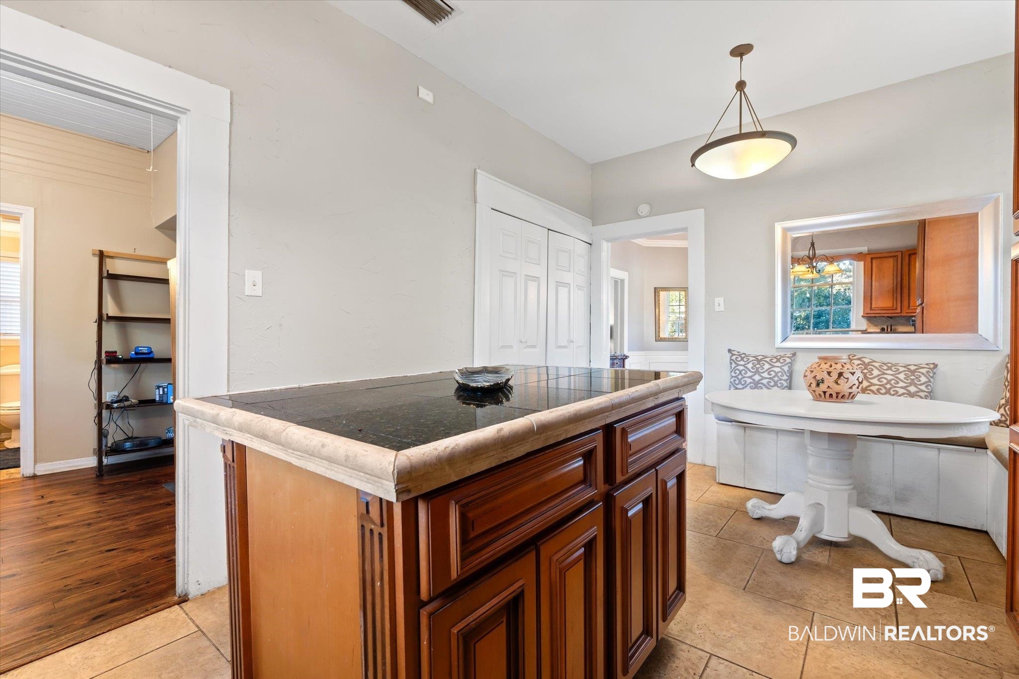 7 Rickarby Place Mobile, AL 36606 - Photo 10 of 20 Kitchen with hanging light fixtures, tile countertops, breakfast area, light hardwood / wood-style floors, and a kitchen island