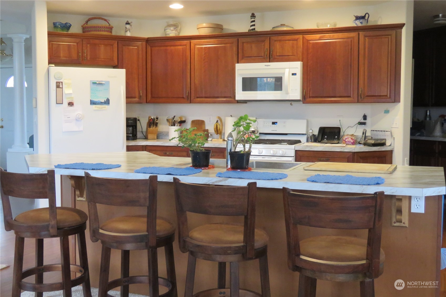 107 South Pass Road, Unit 28 Nooksack, WA 98276 - Photo 4 of 38 a kitchen with a table chairs and a refrigerator
