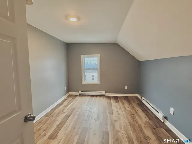 a view of room with window and hardwood floor