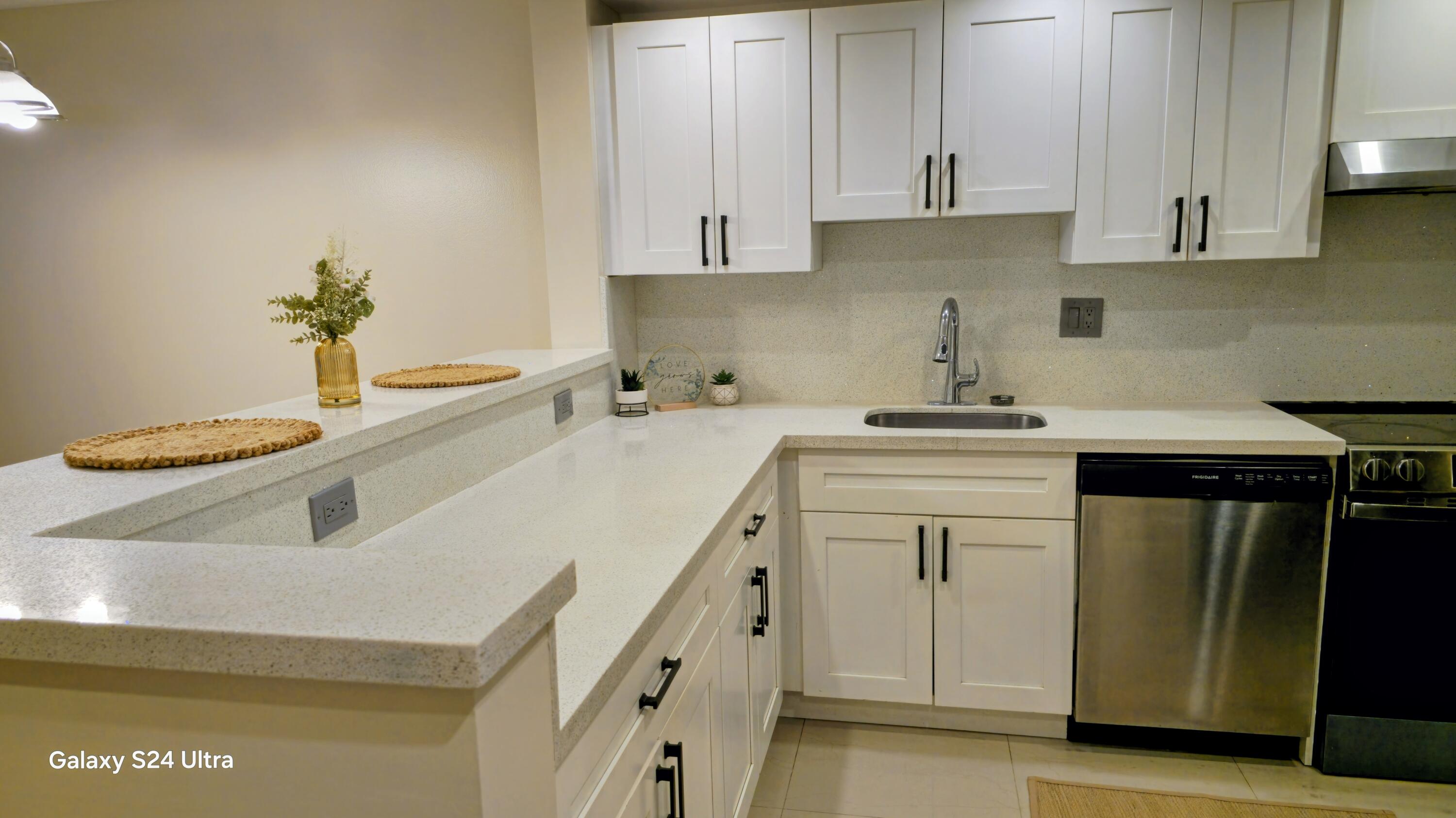 8000 South Colony Circle, Unit 309 Tamarac, FL 33321 - Photo 2 of 16 a kitchen with a sink and cabinets