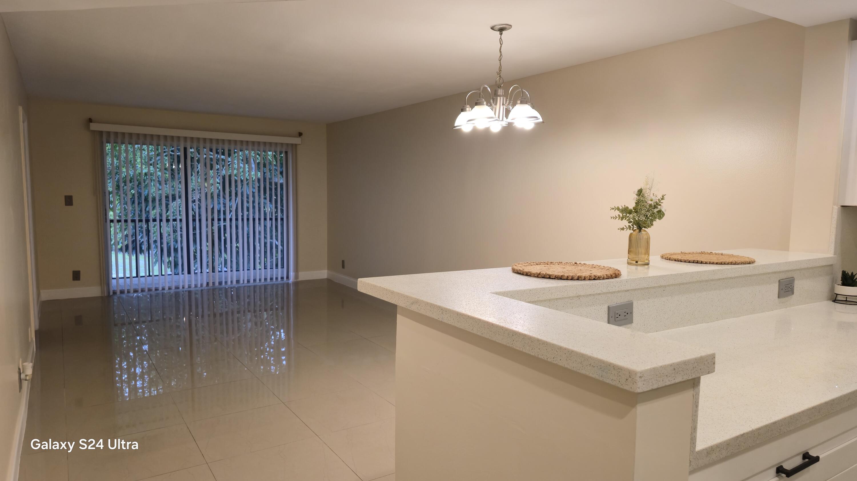 8000 South Colony Circle, Unit 309 Tamarac, FL 33321 - Photo 3 of 16 a view of a kitchen sink and a chandelier