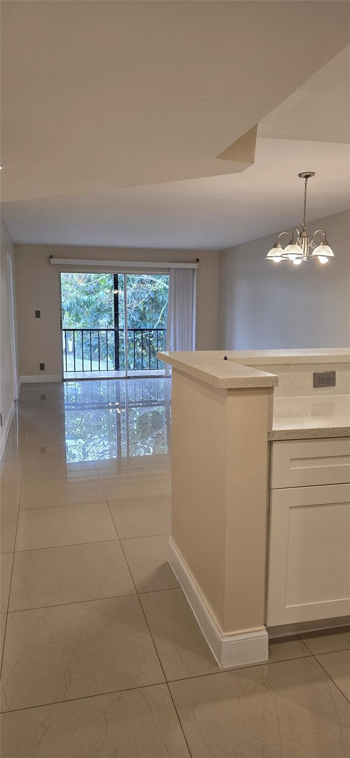 8000 South Colony Circle, Unit 309 Tamarac, FL 33321 - Photo 4 of 16 a view of a kitchen with an empty space and window