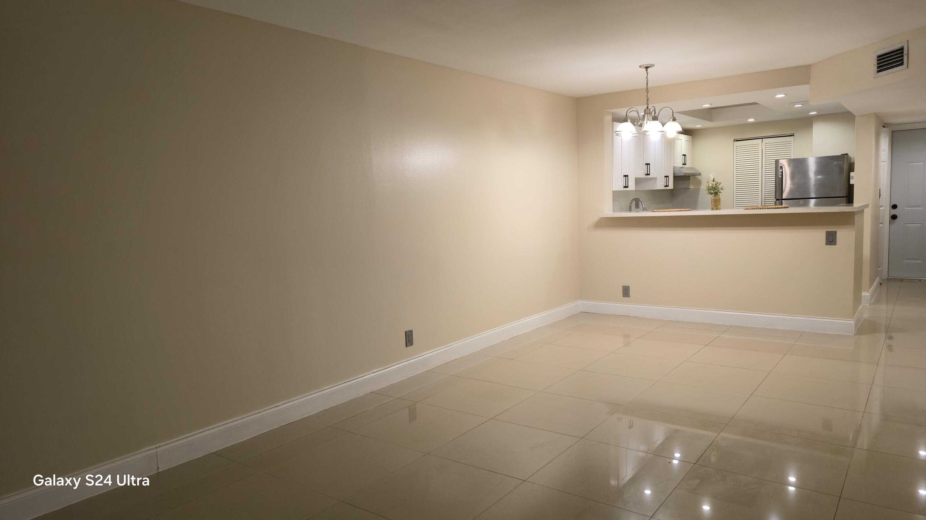 8000 South Colony Circle, Unit 309 Tamarac, FL 33321 - Photo 5 of 16 an empty room with kitchen and sink