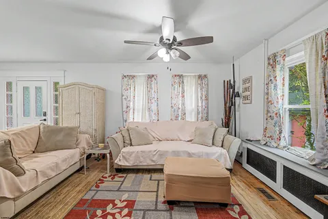 a living room with furniture and a chandelier