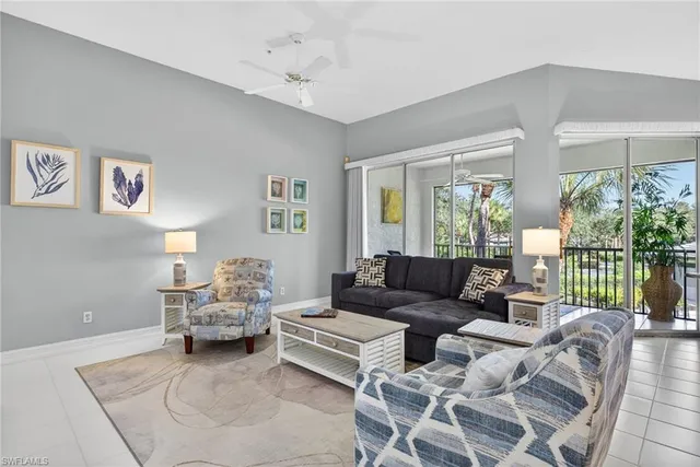 a living room with furniture and a large window with garden view