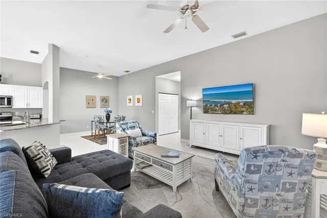 a living room with furniture and flat screen tv