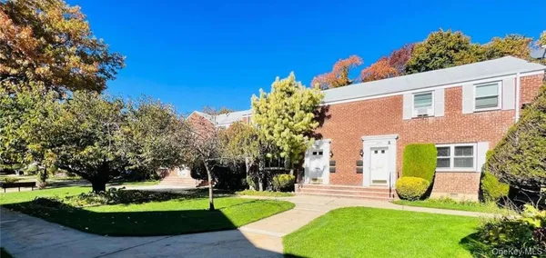 a view of a front of a house with a yard