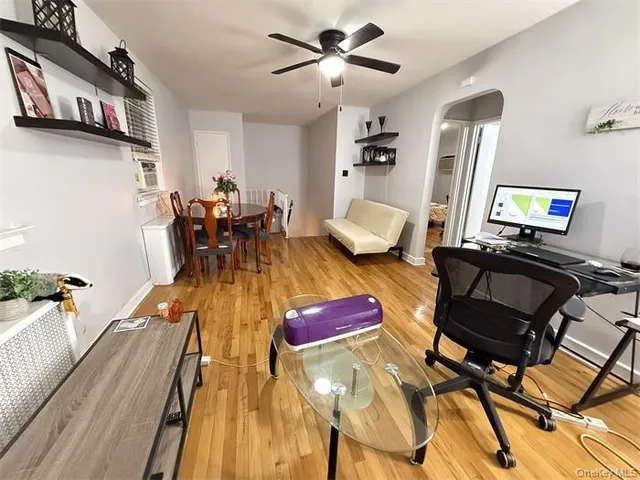 a living room with dining room and wooden floor