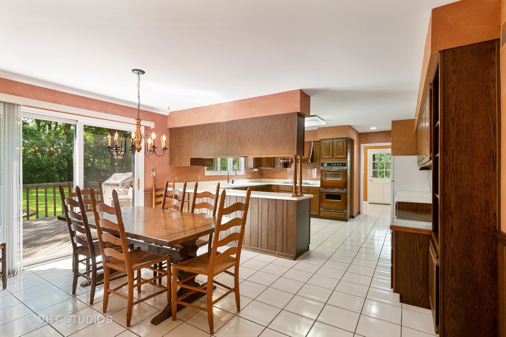 60 North Ridge Road Lake Forest, IL 60045 - Photo 14 of 36 a dining area with furniture a chandelier and kitchen view