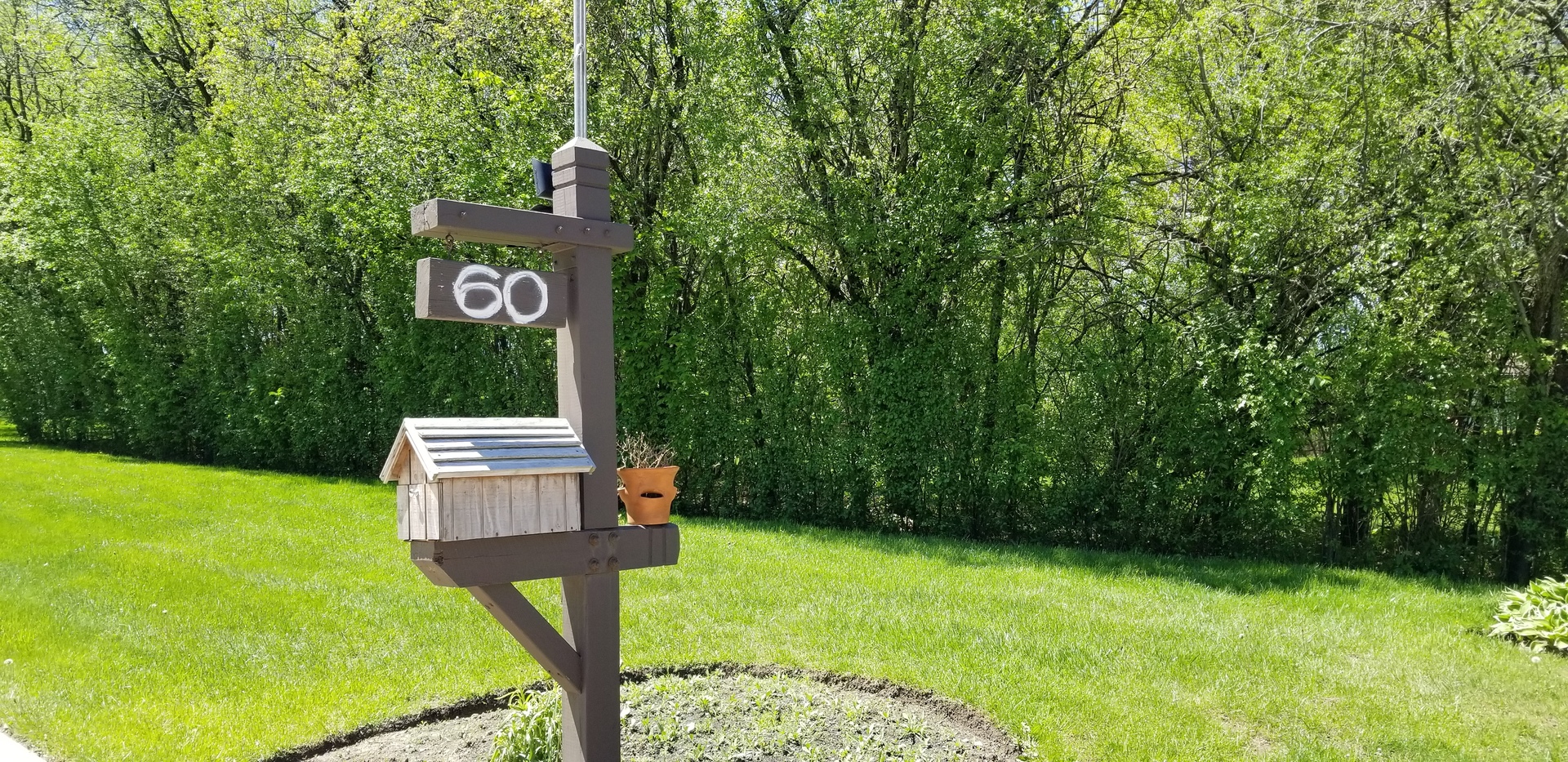 60 North Ridge Road Lake Forest, IL 60045 - Photo 36 of 36 a sign board with a yard and lake view in back