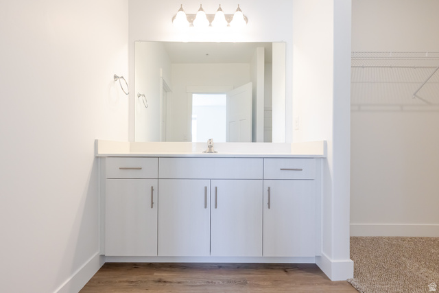 4664 South 680th West, Unit S201 Mapleton, UT 84664 - Photo 10 of 16 Bathroom vanity featuring a single sink, light-colored countertop, and white cabinetry with brushed nickel hardware