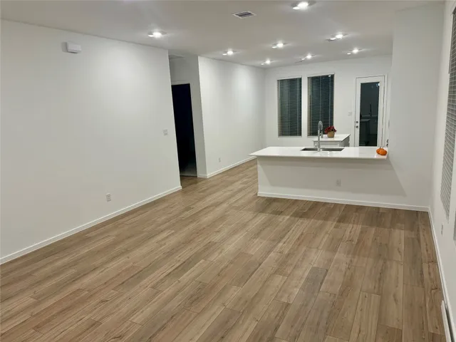 a view of kitchen with stainless steel appliances refrigerator sink and cabinets