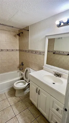 a bathroom with a sink mirror toilet and bathtub