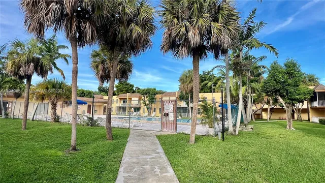 a view of a garden with a house