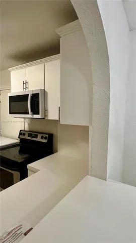 a kitchen with a stove and a refrigerator