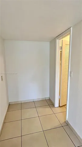 a view of a livingroom with an empty space and a window