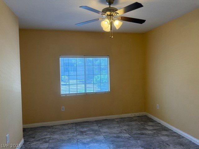 3318 North Decatur Boulevard, Unit 1163 Las Vegas, NV 89130 - Photo 23 of 35 A well-lit bedroom features cool-toned tile flooring and a functional ceiling fan.