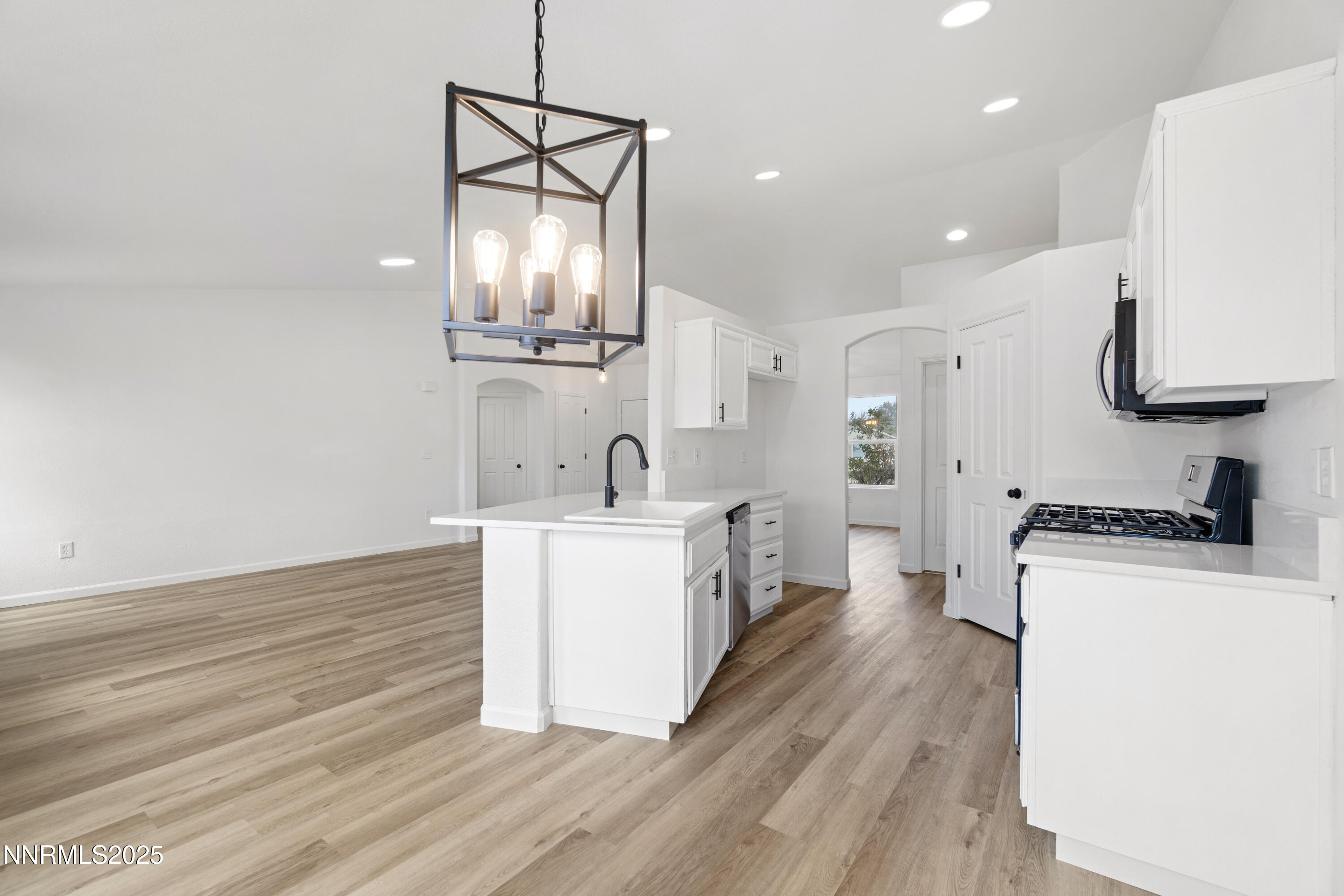 123 Shadow Mountain Drive Fernley, NV 89408 - Photo 11 of 28 a kitchen with a stove a sink and a refrigerator