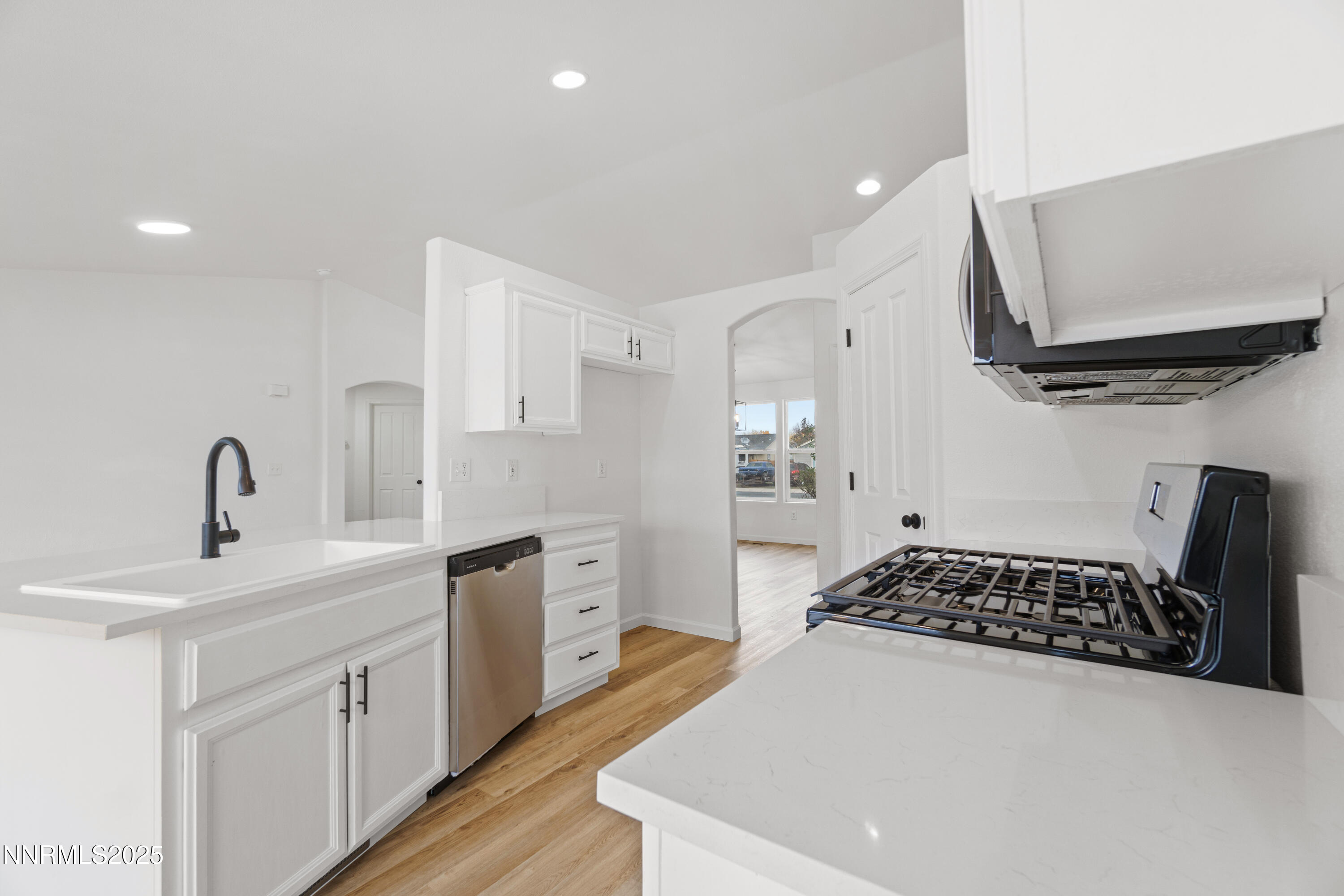 123 Shadow Mountain Drive Fernley, NV 89408 - Photo 12 of 28 a kitchen with stainless steel appliances a sink stove and cabinets