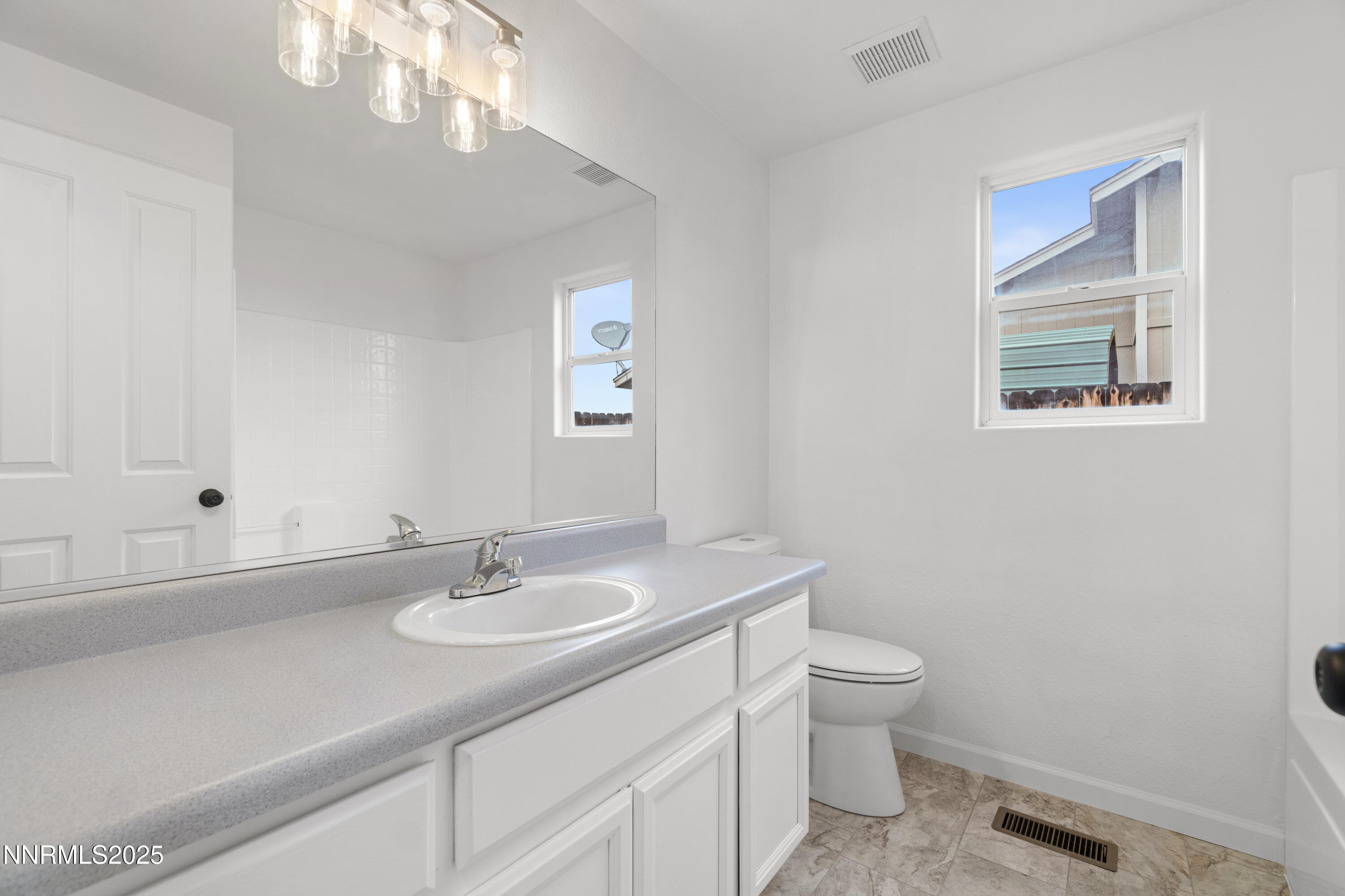 123 Shadow Mountain Drive Fernley, NV 89408 - Photo 17 of 28 a bathroom with a sink a toilet and a mirror