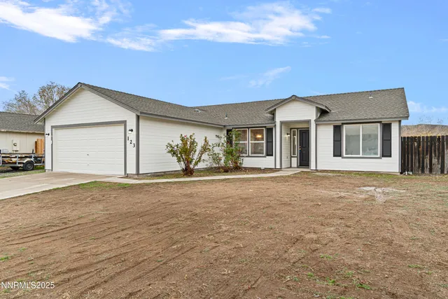 a view of a house with a yard and garage