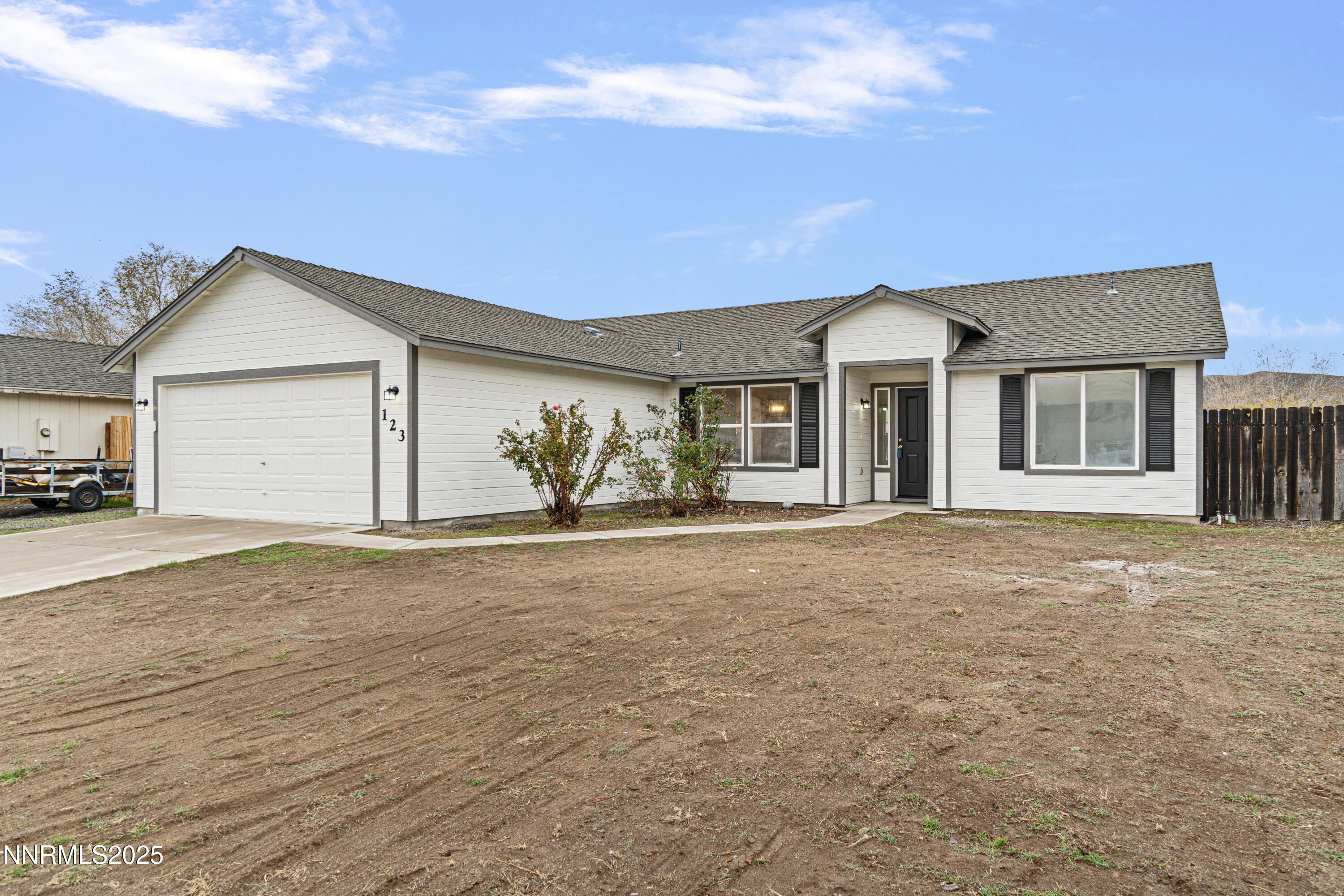 123 Shadow Mountain Drive Fernley, NV 89408 - Photo 3 of 28 a view of a house with a yard and garage