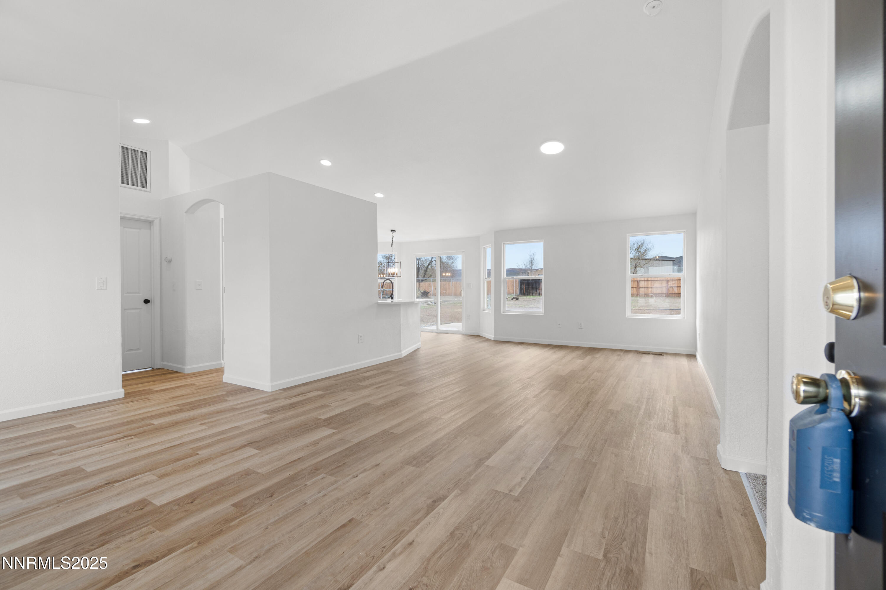 123 Shadow Mountain Drive Fernley, NV 89408 - Photo 6 of 28 a view of an empty room with wooden floor and a window