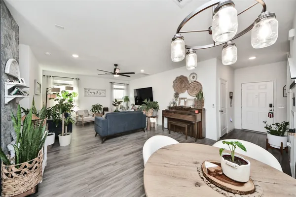 a living room with furniture a fireplace and a chandelier