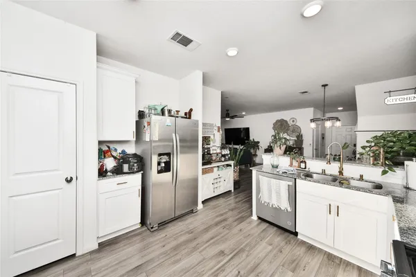 a kitchen with white cabinets and white appliances