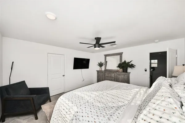 a bedroom with a bed and a flat screen tv