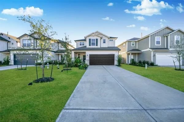 a view of house in front of a big yard