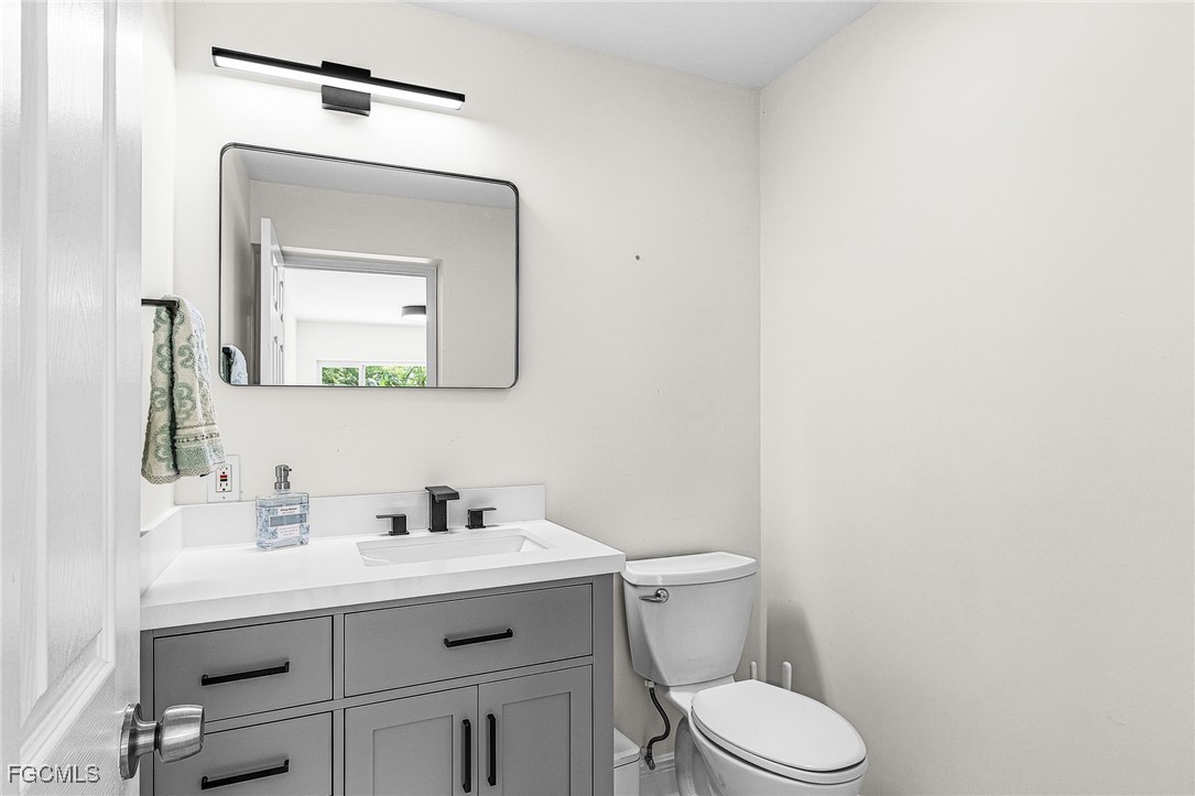 1060 Cooper Drive Naples, FL 34103 - Photo 14 of 33 a bathroom with a toilet sink and mirror