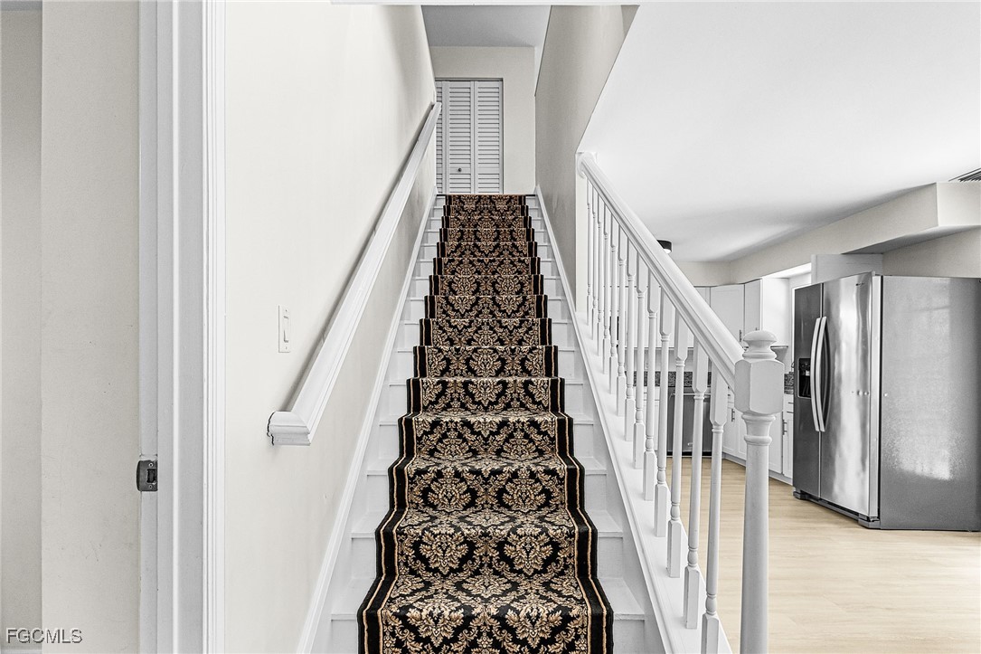 1060 Cooper Drive Naples, FL 34103 - Photo 15 of 33 a view of a hallway with wooden floor and entryway