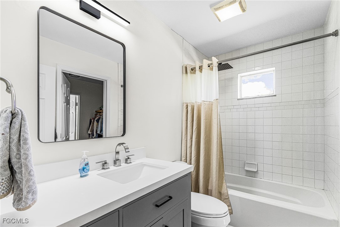 1060 Cooper Drive Naples, FL 34103 - Photo 18 of 33 a bathroom with a sink vanity mirror and toilet