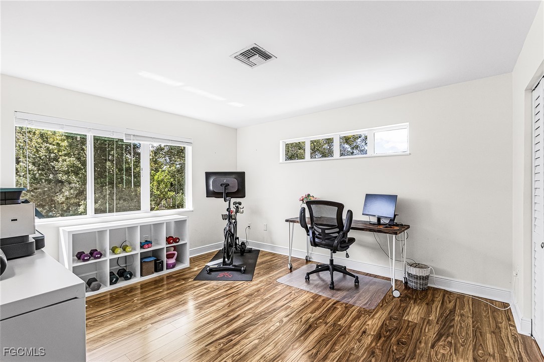 1060 Cooper Drive Naples, FL 34103 - Photo 19 of 33 a view of a workspace with furniture and a window
