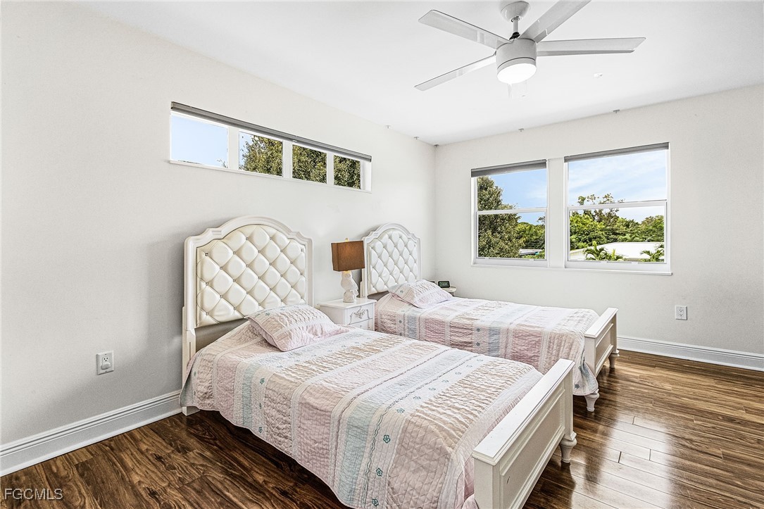 1060 Cooper Drive Naples, FL 34103 - Photo 22 of 33 a bedroom with a bed and wooden floor
