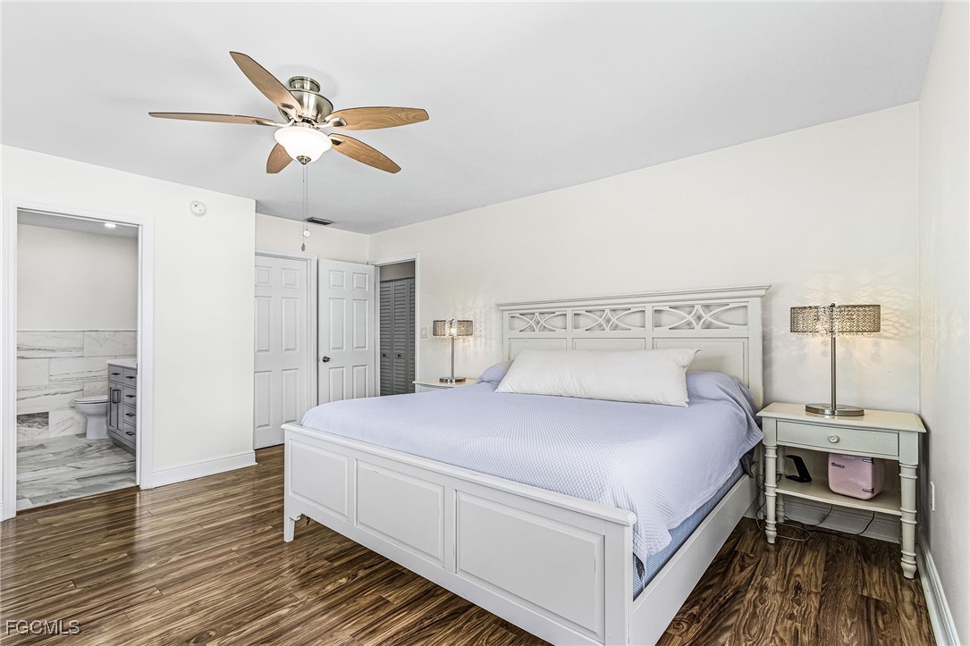 1060 Cooper Drive Naples, FL 34103 - Photo 24 of 33 a bedroom with a bed and a chandelier