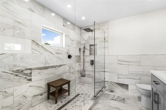 a bathroom with a toilet and a shower