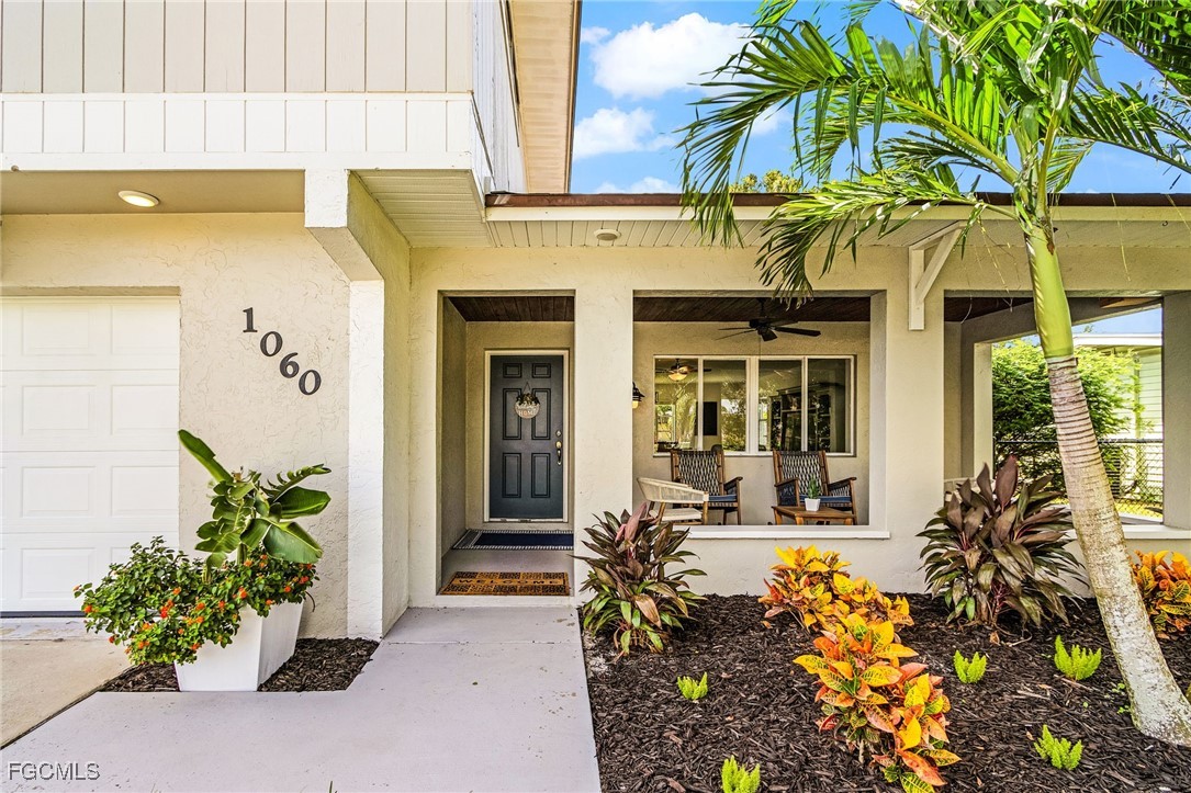 1060 Cooper Drive Naples, FL 34103 - Photo 3 of 33 a front view of a house with glass windows