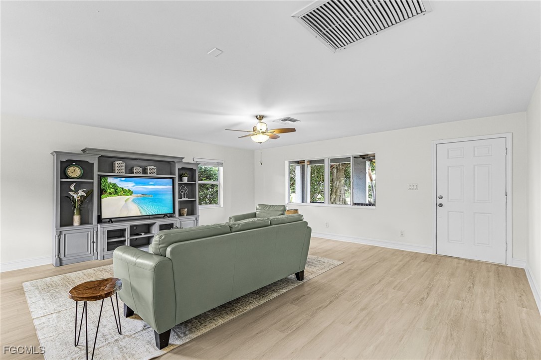 1060 Cooper Drive Naples, FL 34103 - Photo 4 of 33 a living room with furniture and a flat screen tv