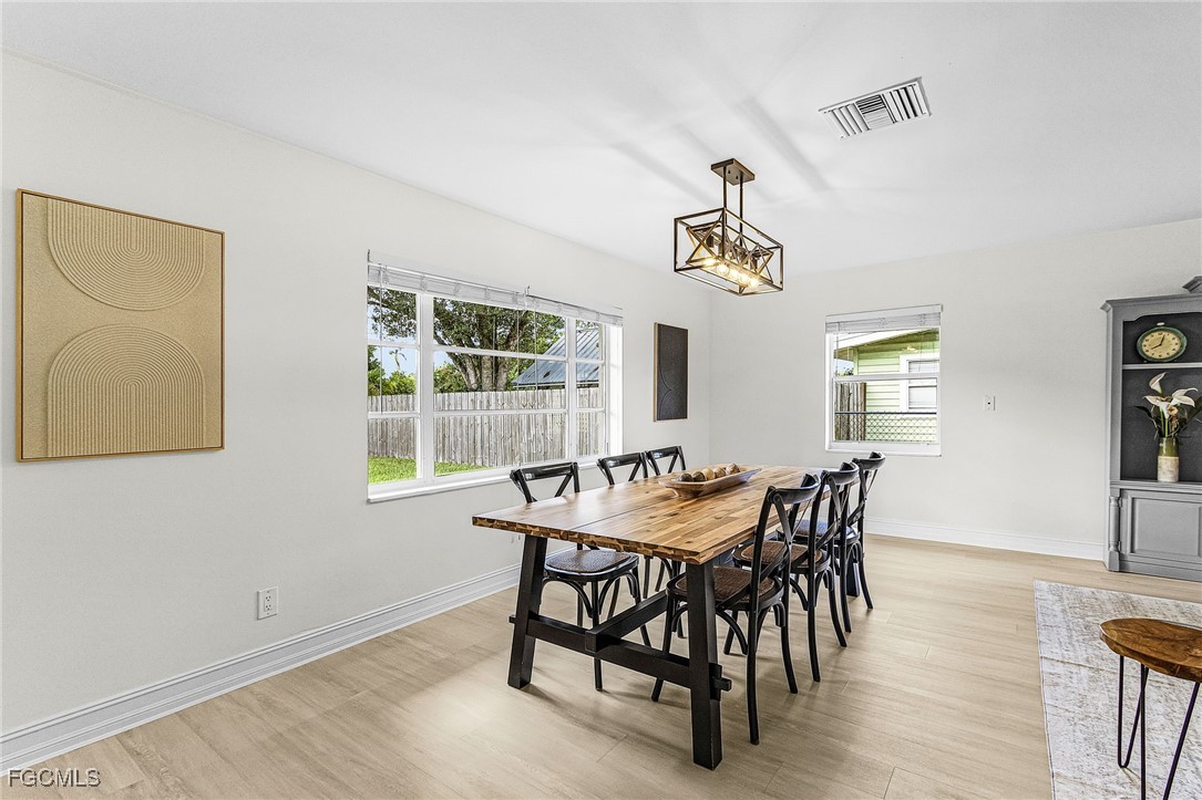 1060 Cooper Drive Naples, FL 34103 - Photo 7 of 33 a view of a dining room with furniture window and wooden floor
