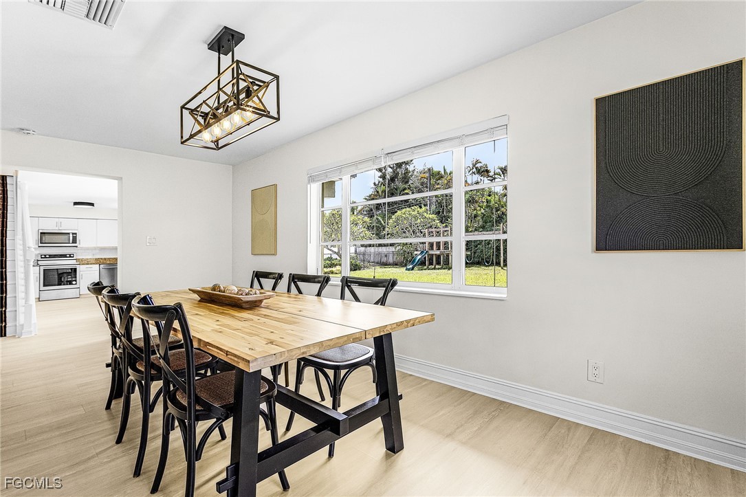 1060 Cooper Drive Naples, FL 34103 - Photo 8 of 33 a view of a dining room with furniture and a window