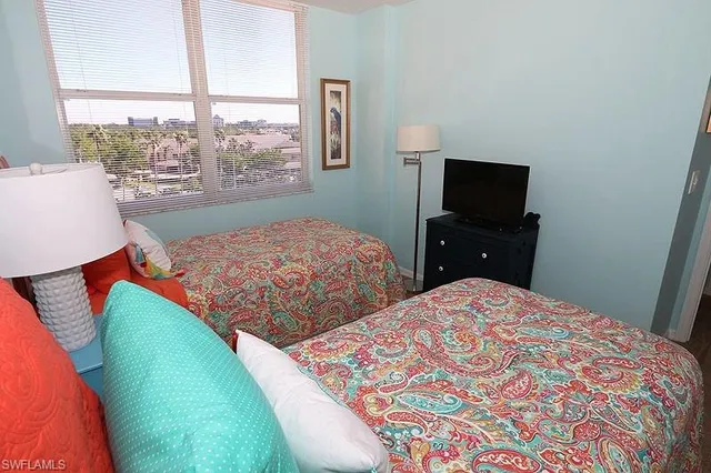 a bedroom with a bed and a television