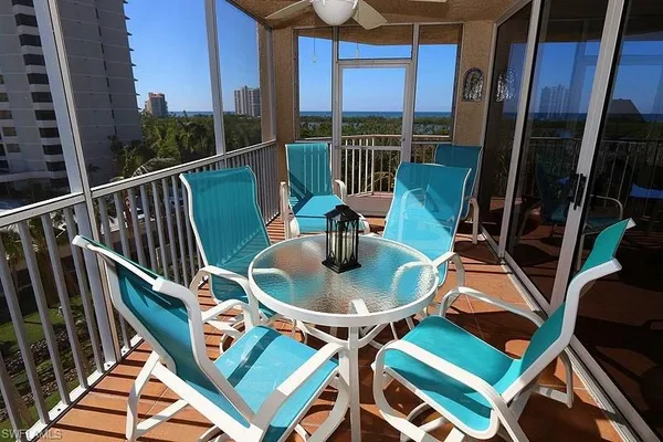 a view of a balcony with furniture and wooden floor
