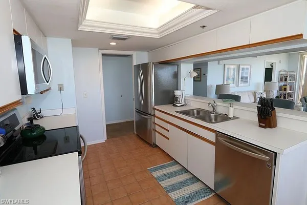 a kitchen with stainless steel appliances granite countertop a sink and a refrigerator
